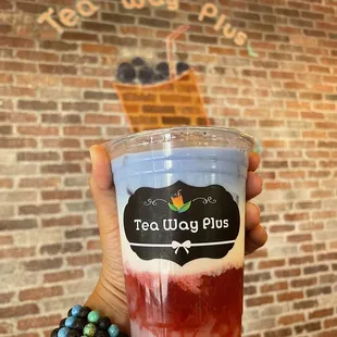 a hand holding a cup of tea