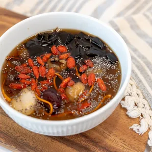 a bowl of soup on a cutting board