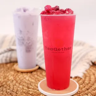 two cups of tea with raspberries in them