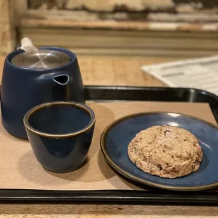 a tray with a cookie and a cup of coffee