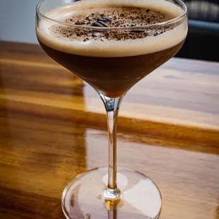 a glass of coffee on a table