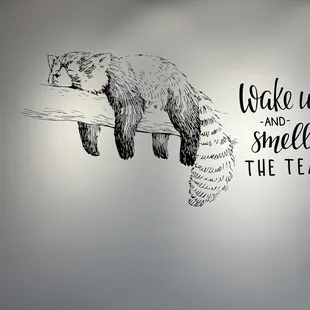 a black and white drawing of a raccoon