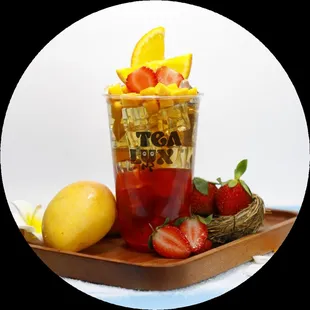 a cup of tea with strawberries and lemons
