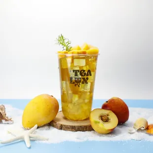 a glass of iced tea with peaches