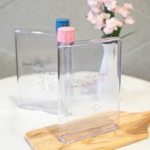 a bottle of water on a wooden stand