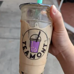 a hand holding a cup of coffee
