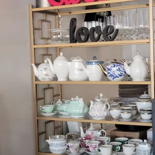 a shelf of teapots and dishes