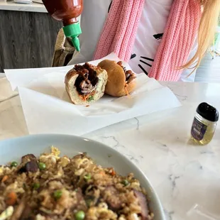 a woman sitting at a table with a plate of food