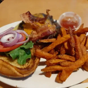 Monday special burger with added bacon and sweet potato fries