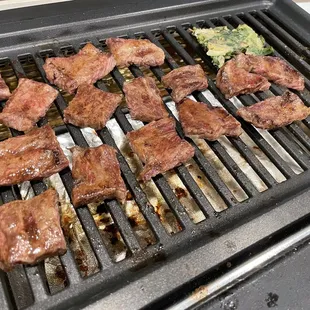 teaks being cooked on a grill
