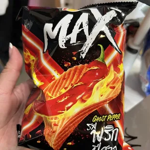 a hand holding a bag of chips