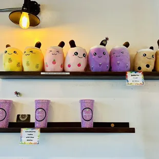 Adorable stuffed boba mascots and glittery cups for sale.