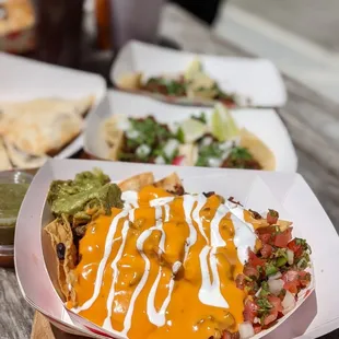a variety of mexican food on a wooden table