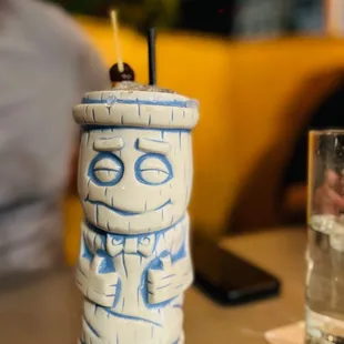 a tiki mug on a table