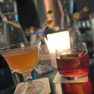 two cocktails on a bar