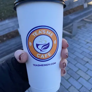 a person holding a coffee cup