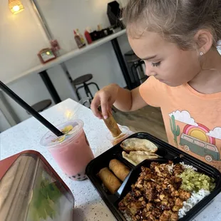 $9.95 Bento box- Chicken and rice with vegetable spring rolls and pan fried chicken dumplings.