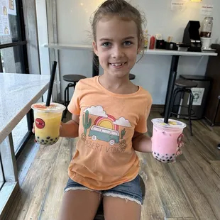 She couldn't decide between mango or strawberry so she convinced me to get one so she could try both.