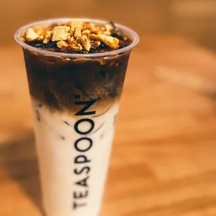 a cup of ice cream with chocolate and nuts