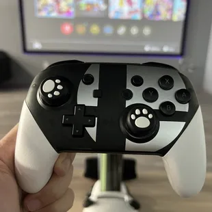 a hand holding a controller