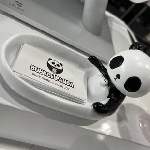 a panda sitting on a toilet