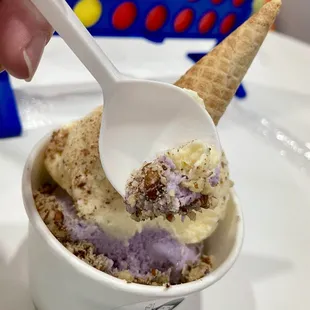 Two scoops gelato- Taro and Mango flavors topped with pecans.