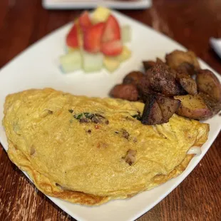 Veggie omelette with home fries and fruit! It was delic!