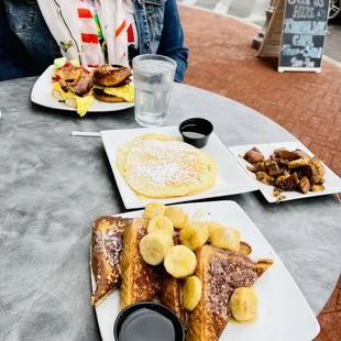 Bananas Foster French Toast, Short stack pancakes, roasted potatoes, and egg sandwich.