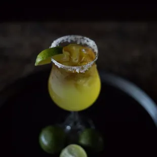 a glass of tea with a lime garnish