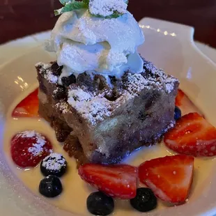 a piece of cake with whipped cream and berries