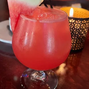 a watermelon drink with a slice of watermelon