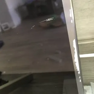 scratch on screen.  Large stick glued so right the white sticker is stuck to the screen.  The sticker they glued to conceal the scratch.