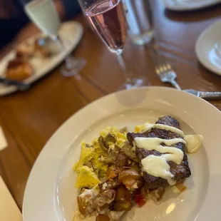 a plate of food and a glass of wine