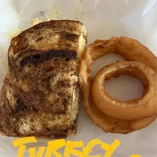 Turkey reuben with onion rings.