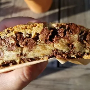 a hand holding a half eaten cookie