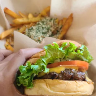 a hamburger with lettuce, tomato, and cheese
