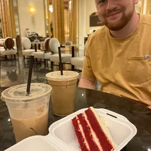 a man sitting at a table with a piece of cake