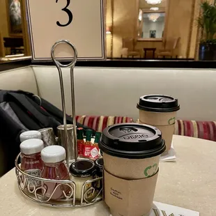 2 coffees and a table number for receiving our hot food order