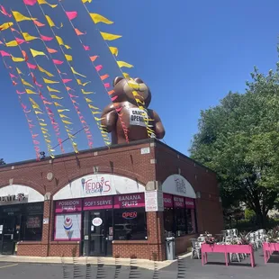 a large teddy bear on top of a building