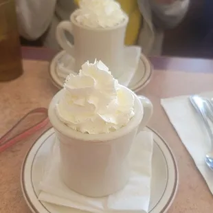 two cups of coffee with whipped cream
