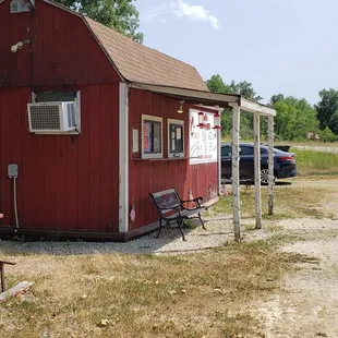 a red building and a picnic table
