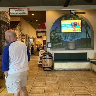 a man standing in front of a tv