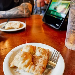 a plate of crepes and a glass of water