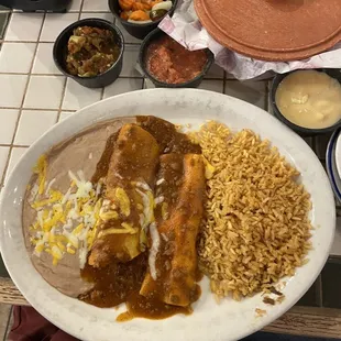 Cheese enchilada, beef enchilada with fried rice and refried beans