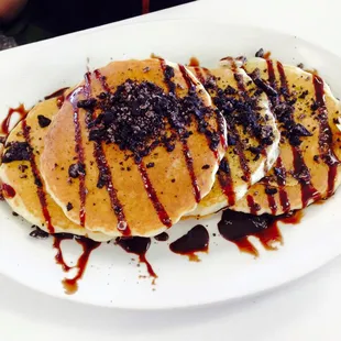 a plate of pancakes with chocolate sauce