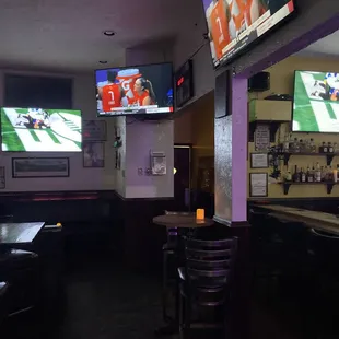 a bar with two televisions