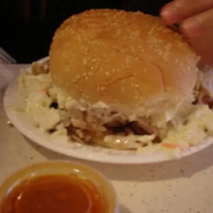 Chopped chicken sandwich with slaw and sauce. Yum, but note the tiny plate.