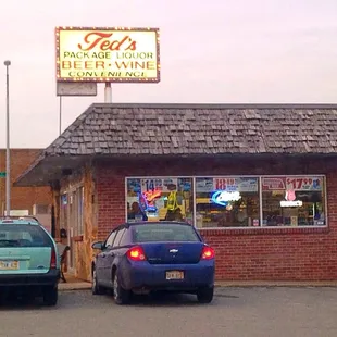 two cars parked in front of a building