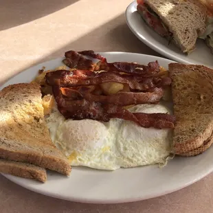 2 eggs over easy with home fries, bacon and rye toast