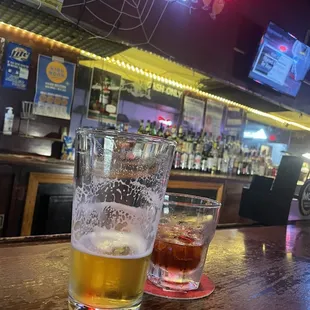 two glasses of beer on a bar